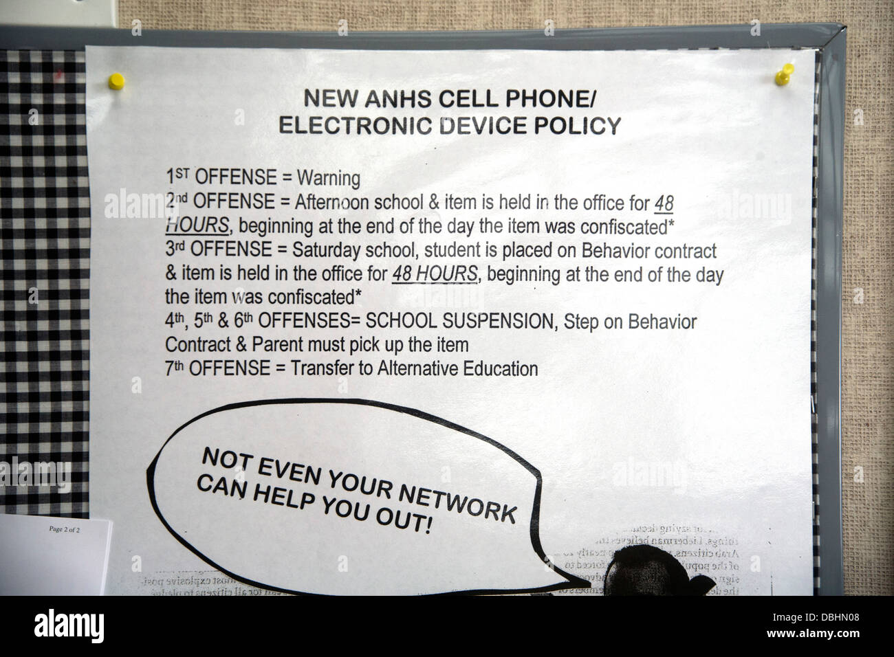 A sign on a suburban high school wall in Aliso Viejo, CA, lists escalating penalties for unauthorized use of cell phones Stock Photo