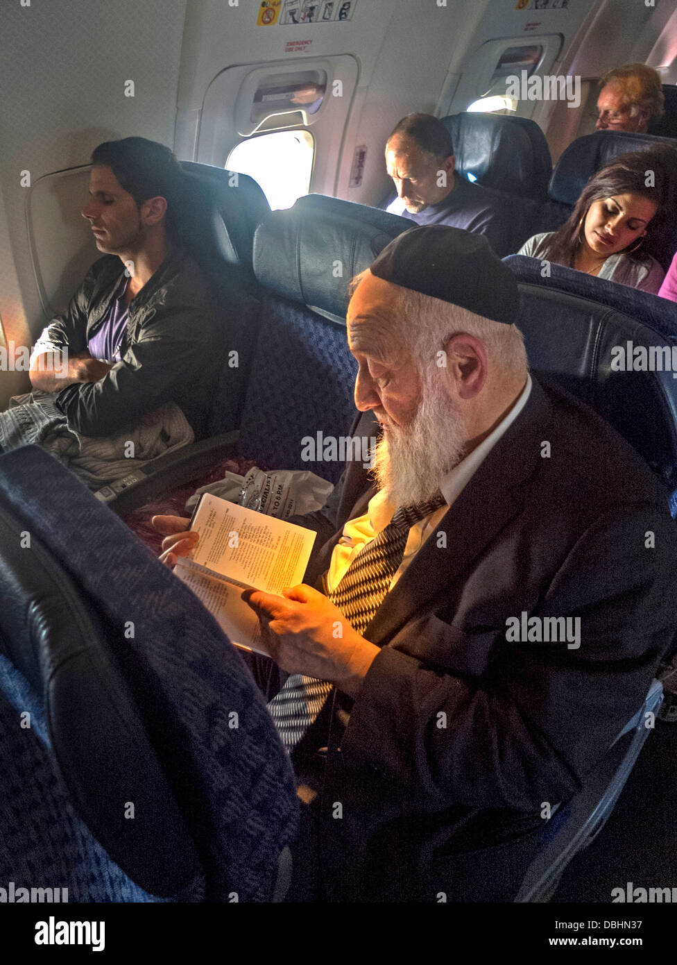 Wearing a yarmulke skull cap, an bearded Orthodox Jew reads from a book