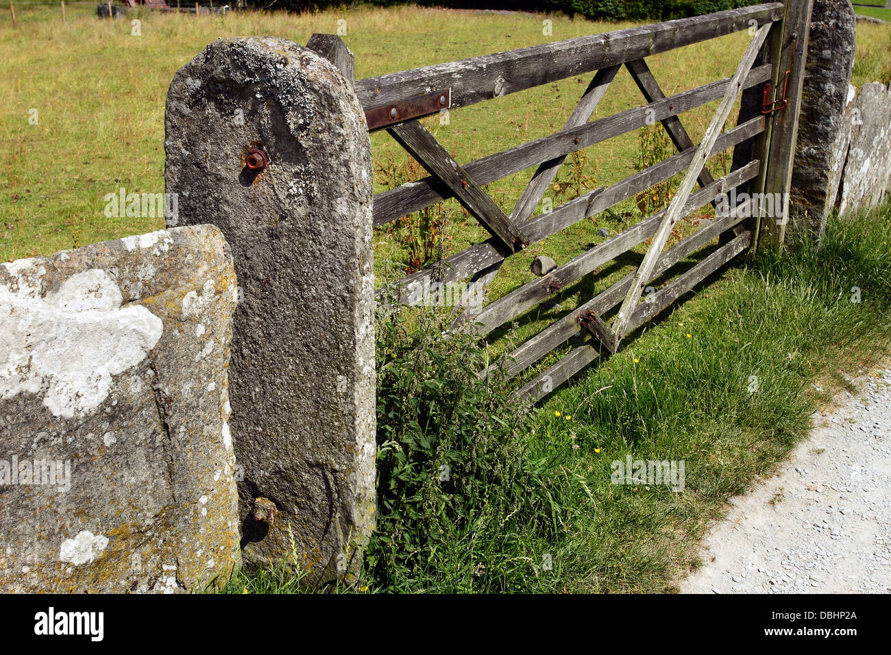 A traditional wooden farm gate with stone gateposts in Hawkeshead in