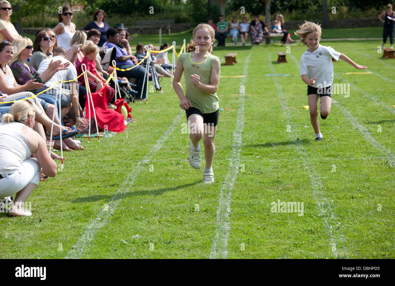 Young girl winning sprint race on school sports day Chipping Campden UK Stock Photo