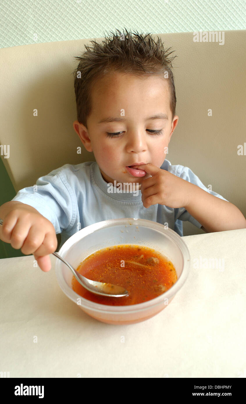Little boy eating tomato soup Stock Photo Alamy