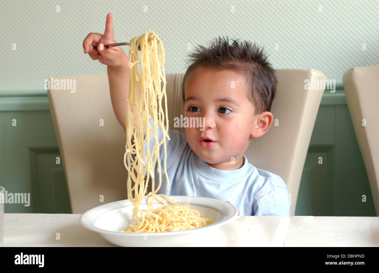 Little boy eating spaghetti Stock Photo Alamy