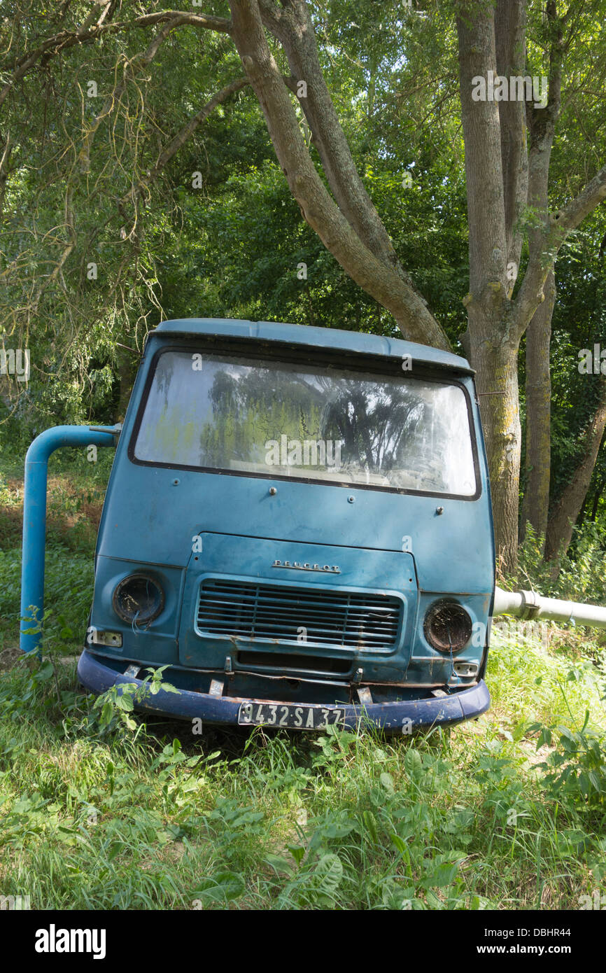 An old Peugeot van converted and fitted with a water pump to help irrigate fields Stock Photo