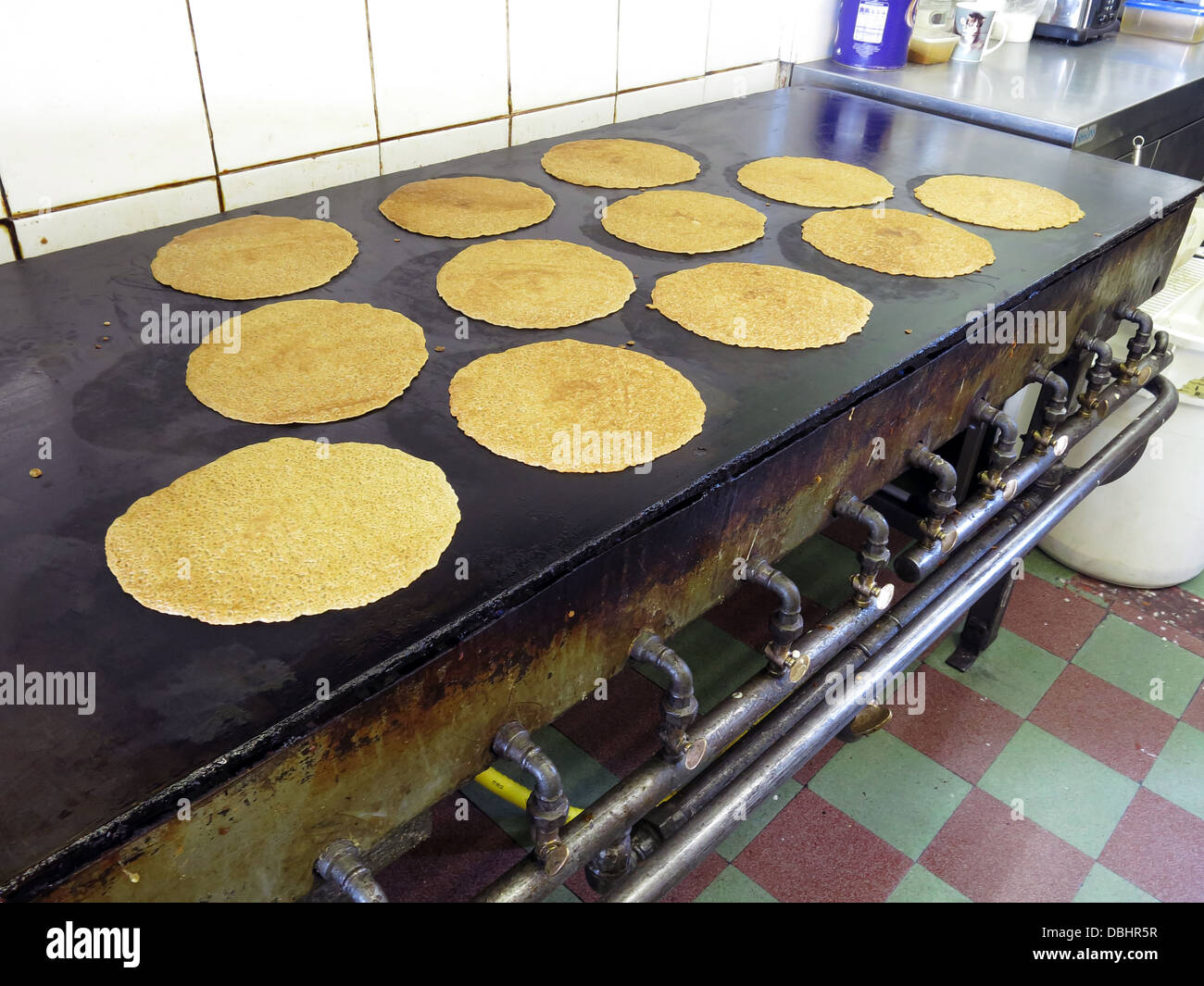 Interior of a traditional Stoke / Staffordshire Oatcake shop, with bright yellow frontage, cooking on an iron griddle 'baxton' Stock Photo