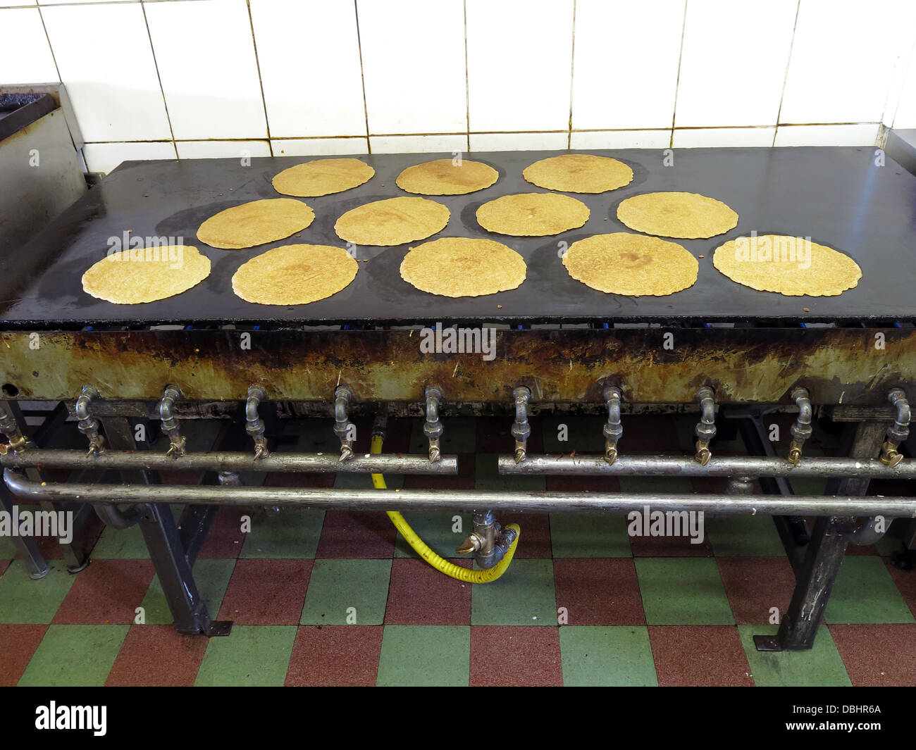 Interior of a traditional Stoke / Staffordshire Oatcake shop, with bright yellow frontage, cooking on a baxton iron griddle Stock Photo