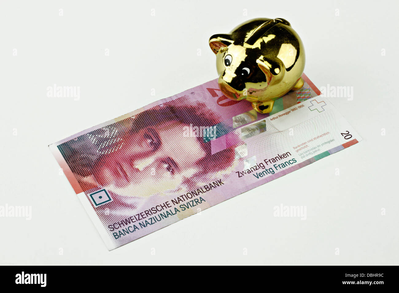 Swiss Twenty Franken Bank Note with gold Piggy Bank Money Box Stock Photo