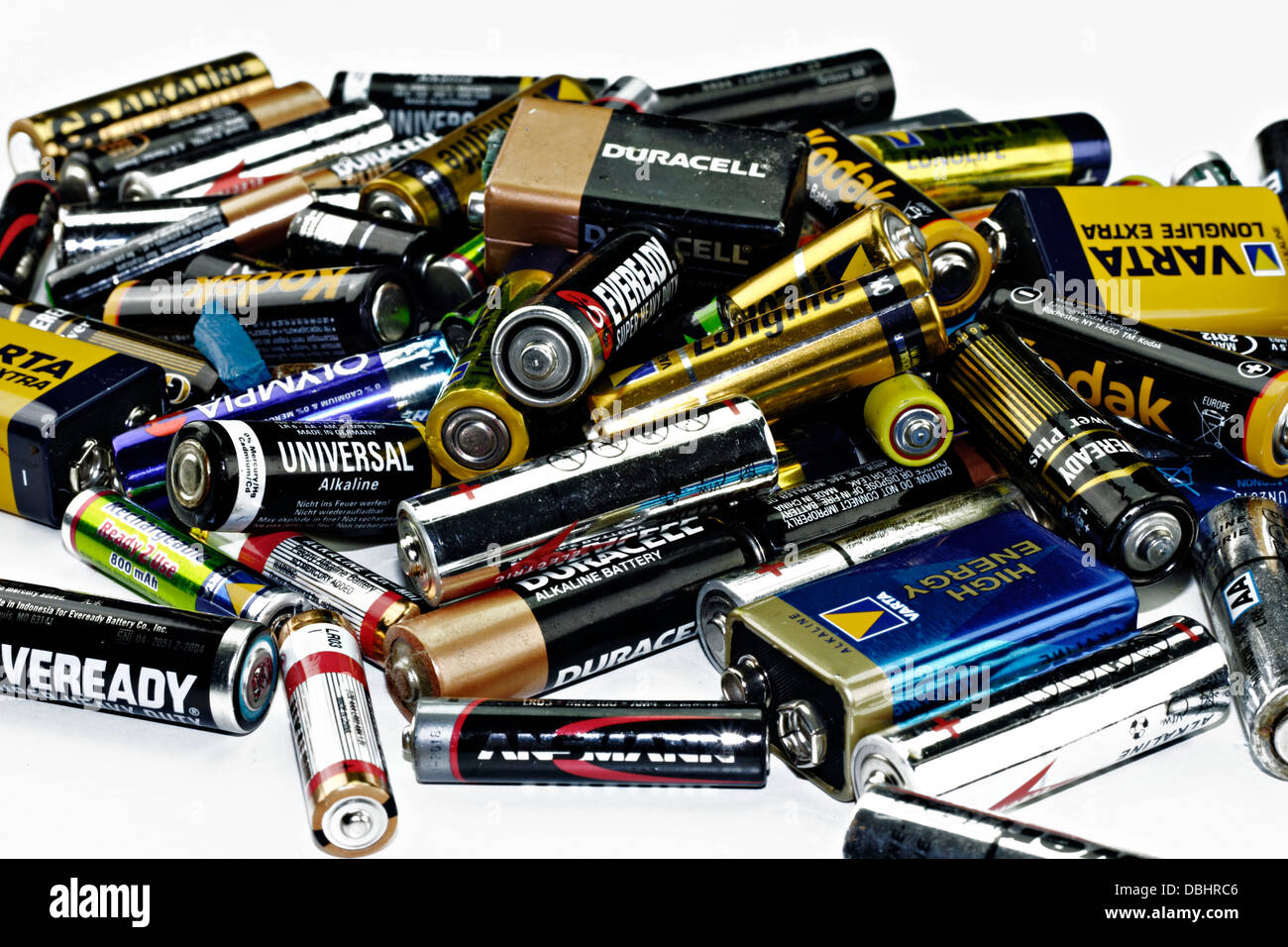 Old used alkaline batteries on white background Stock Photo