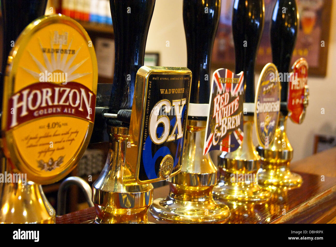 Wadworth of Devizes real ale handpumps and pump clips on a pub bar Stock Photo
