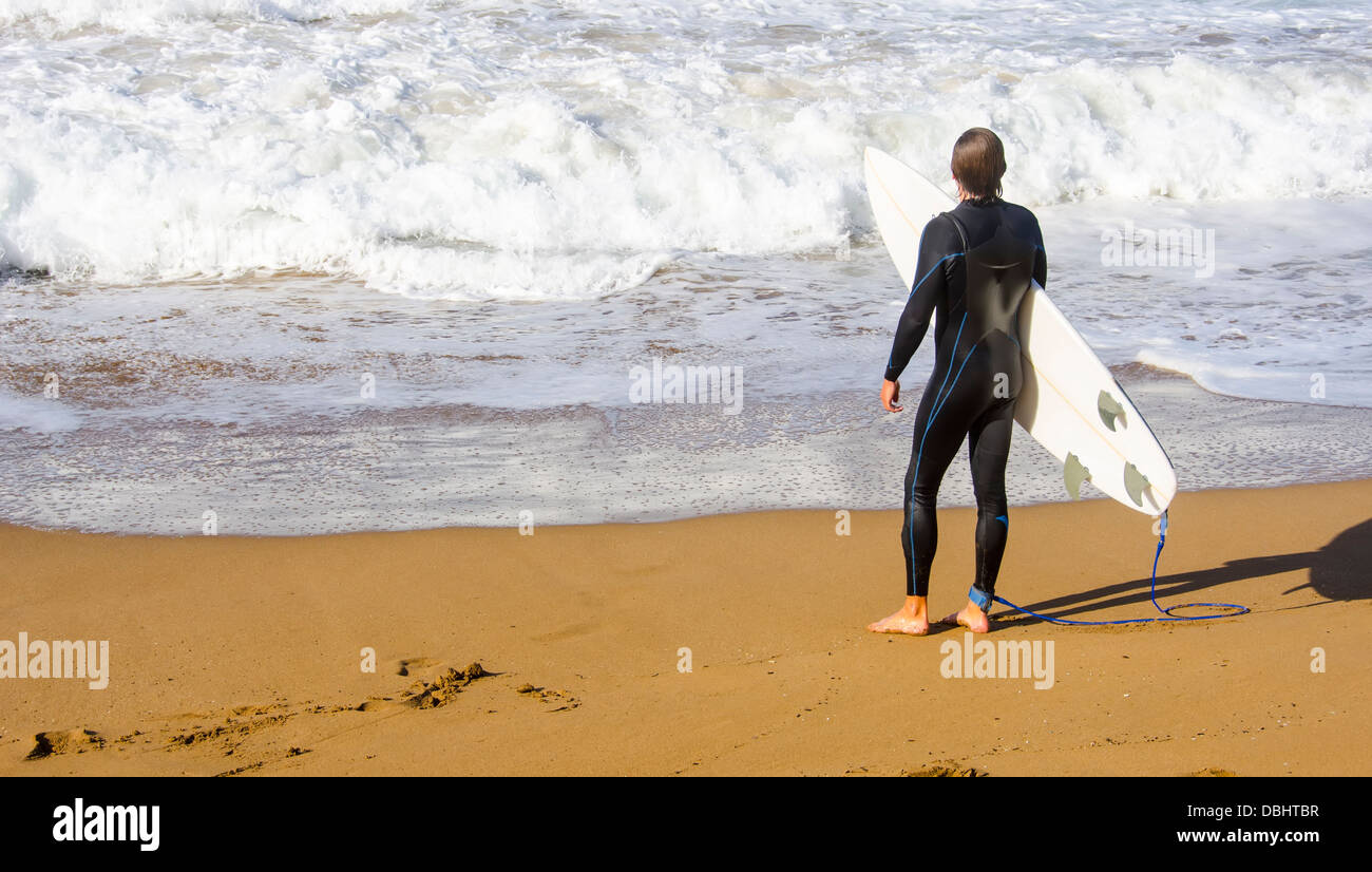 Surfer waiting in the sand at the beach surfing Zarautz Stock Photo