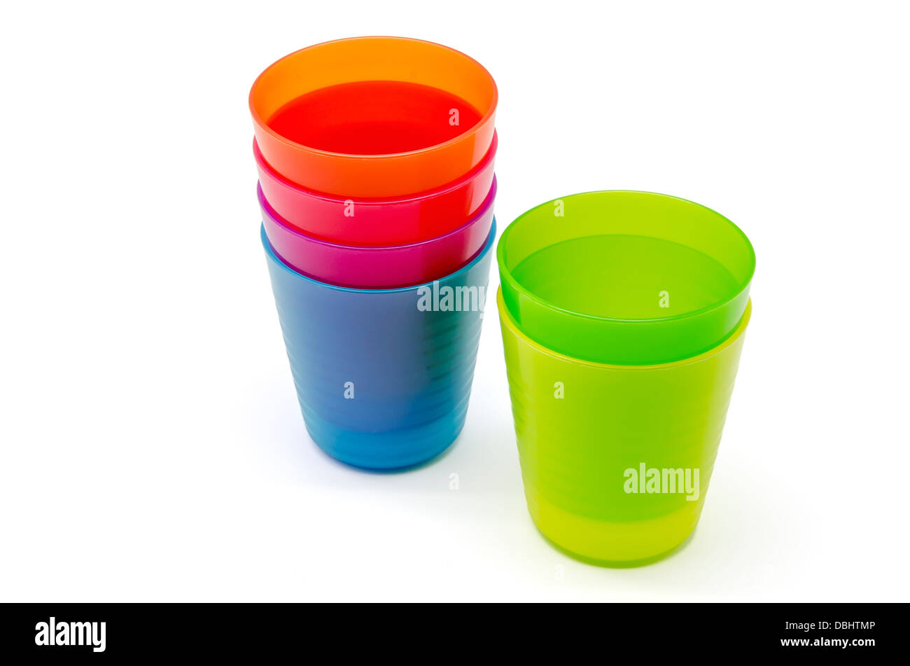 Plastic tableware of various colors on white background Stock Photo