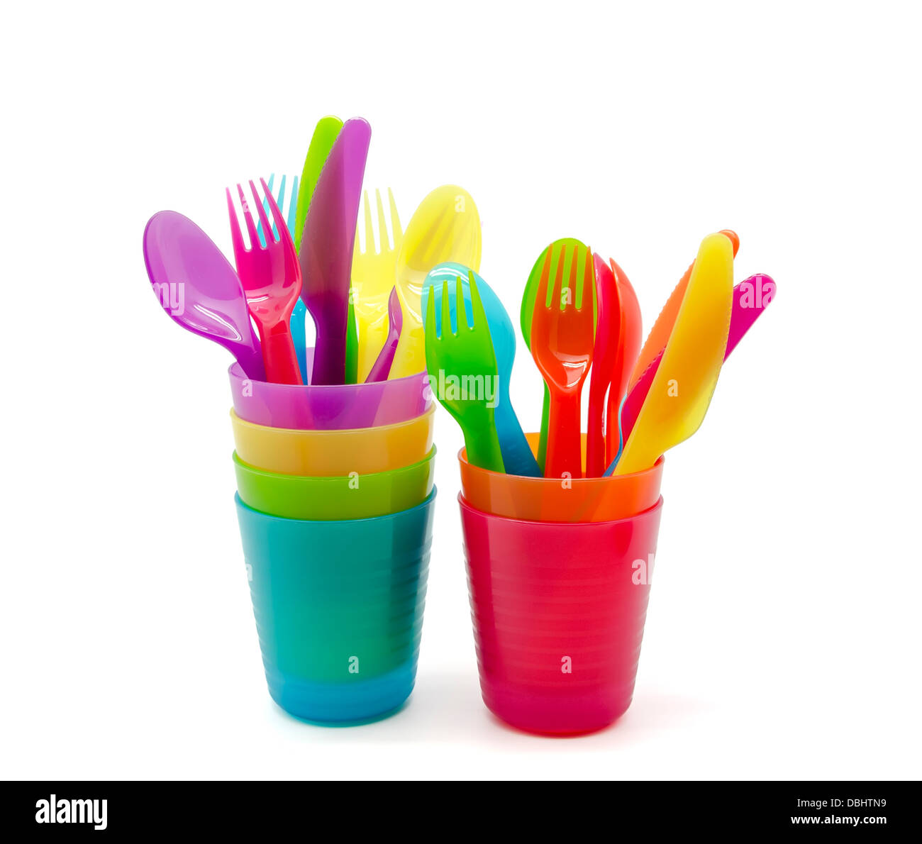 Plastic tableware of various colors on white background Stock Photo