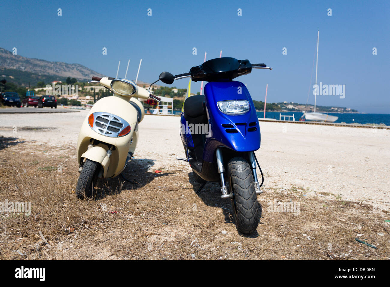 Two scooters on the beach at Avlaki Corfu Stock Photo