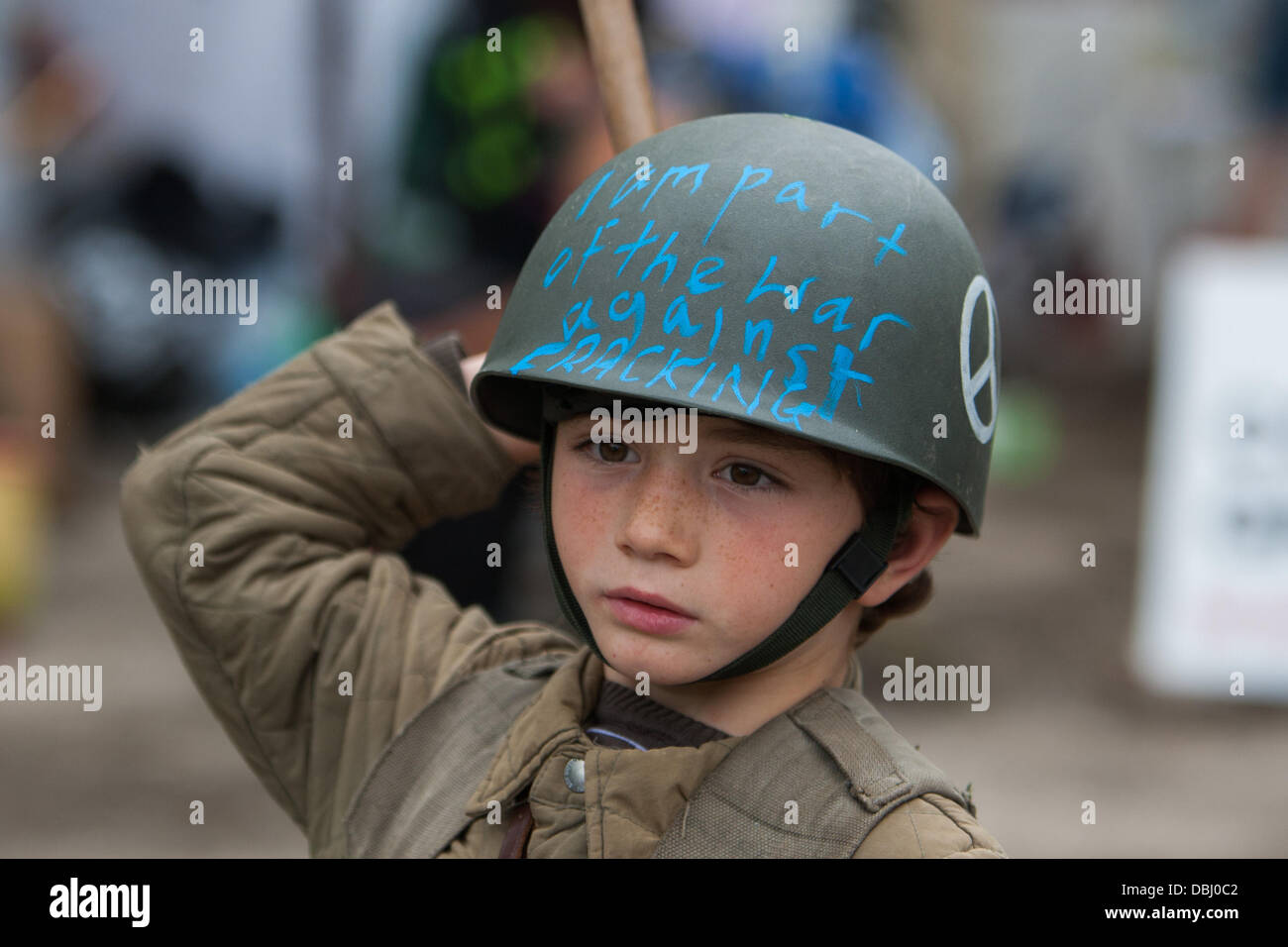 Balcombe, West Sussex, UK. 31st July, 2013. Young boy dressed as soldier with anti fracking slogan on helmet at protest against Cuadrilla drilling & fracking just outside the village of Balcombe in West Sussex. Balcombe, West Sussex, UK. Credit:  martyn wheatley/Alamy Live News Stock Photo