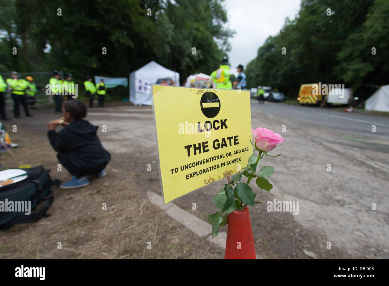 Balcombe, West Sussex, UK. 31st July, 2013. Lock the Gate placard and flower on road cone at Cuadrilla site entrance. Protest against Cuadrilla drilling & fracking just outside the village of Balcombe in West Sussex. Balcombe, West Sussex, UK. Credit: martyn wheatley/Alamy Live News Stock Photo