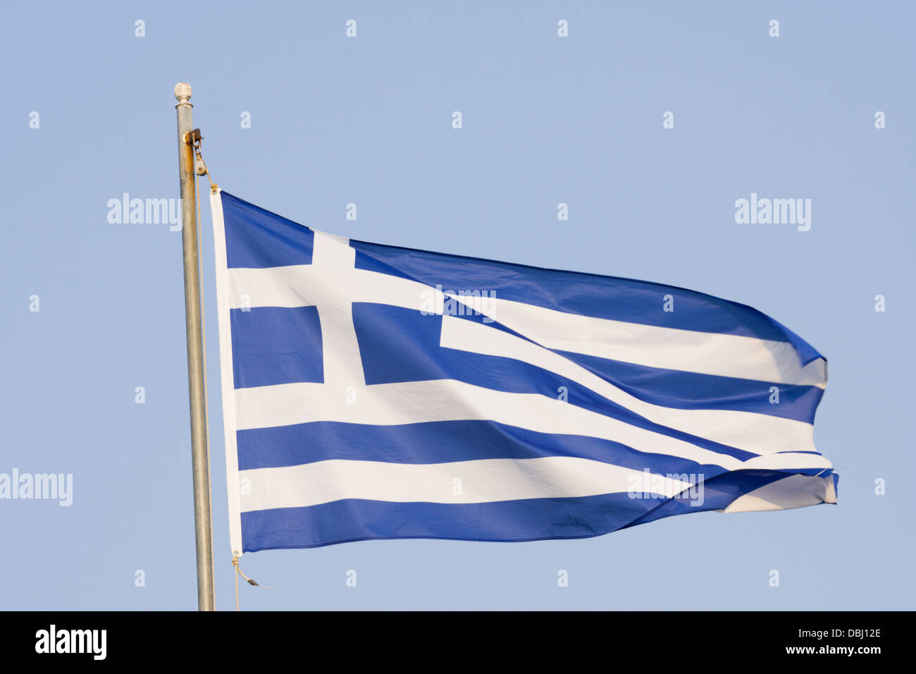 Greek flag flying in breeze on falg pole Stock Photo