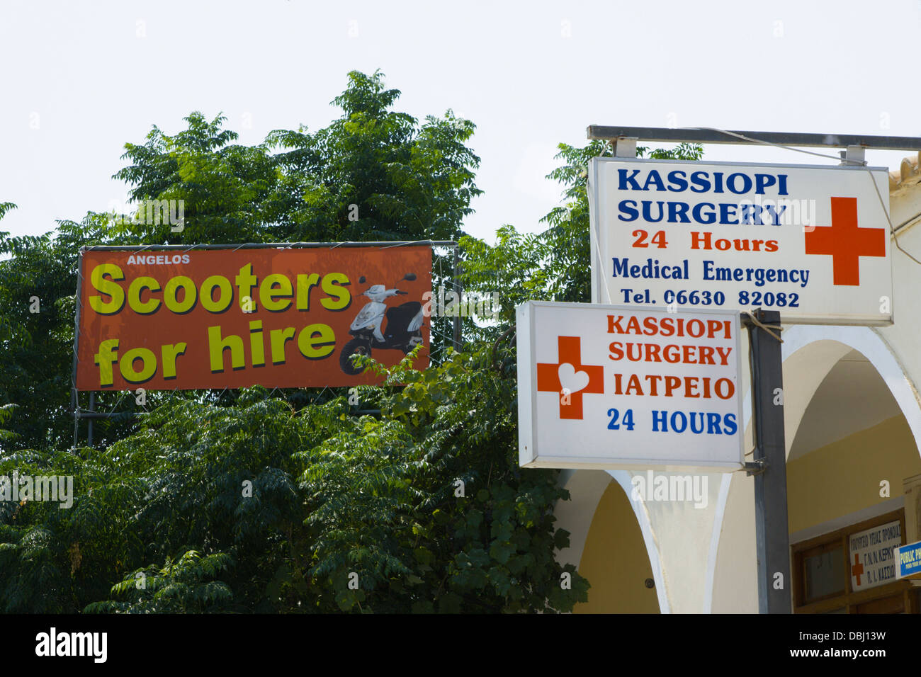 Scooters for hire sign with surgery sign beneath Stock Photo