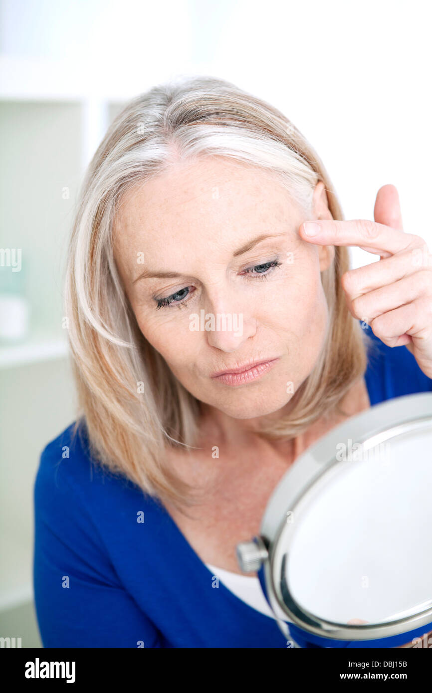 ELDERLY PERSON WITH MIRROR Stock Photo