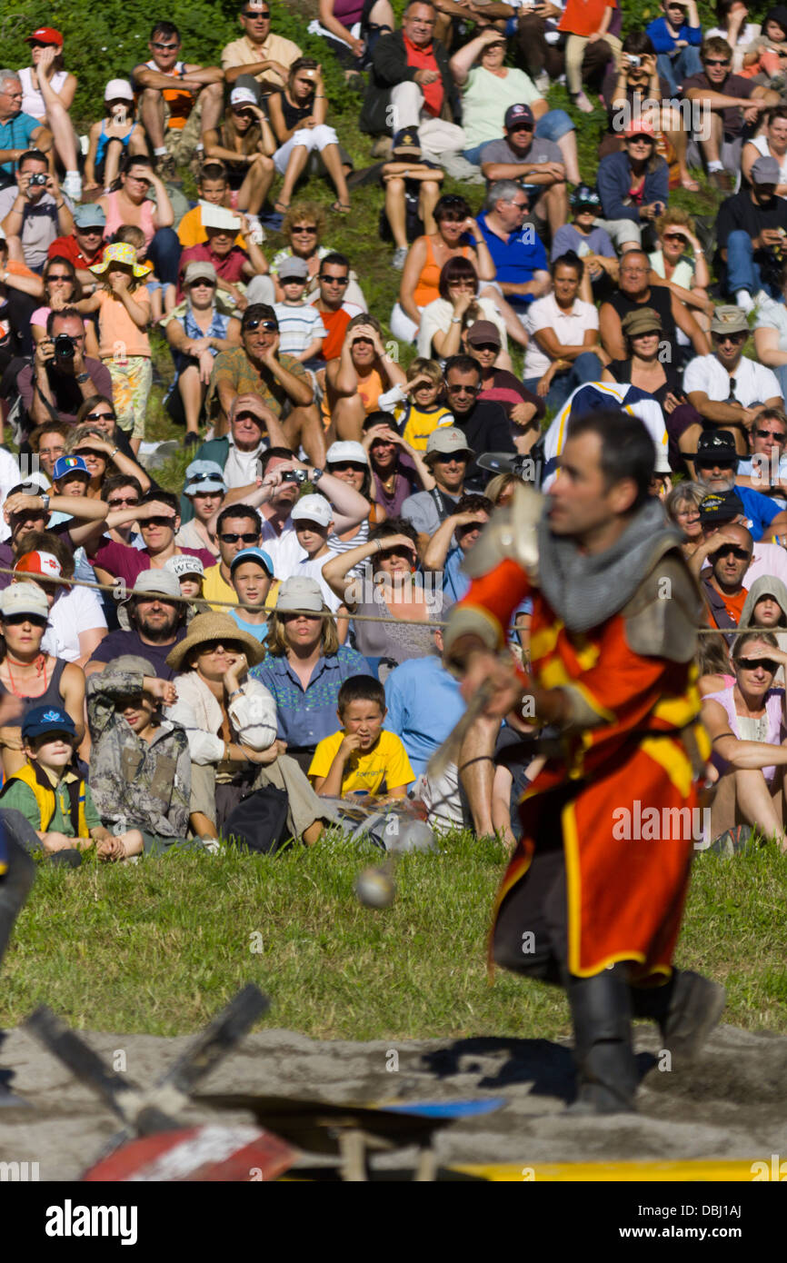 Audience watching knights fight on foot at French Mediaeval fayre Stock Photo
