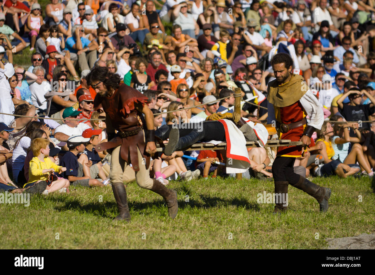 Wounded knight is carried on a stretcher at a French Mediaeval Fayre Stock Photo