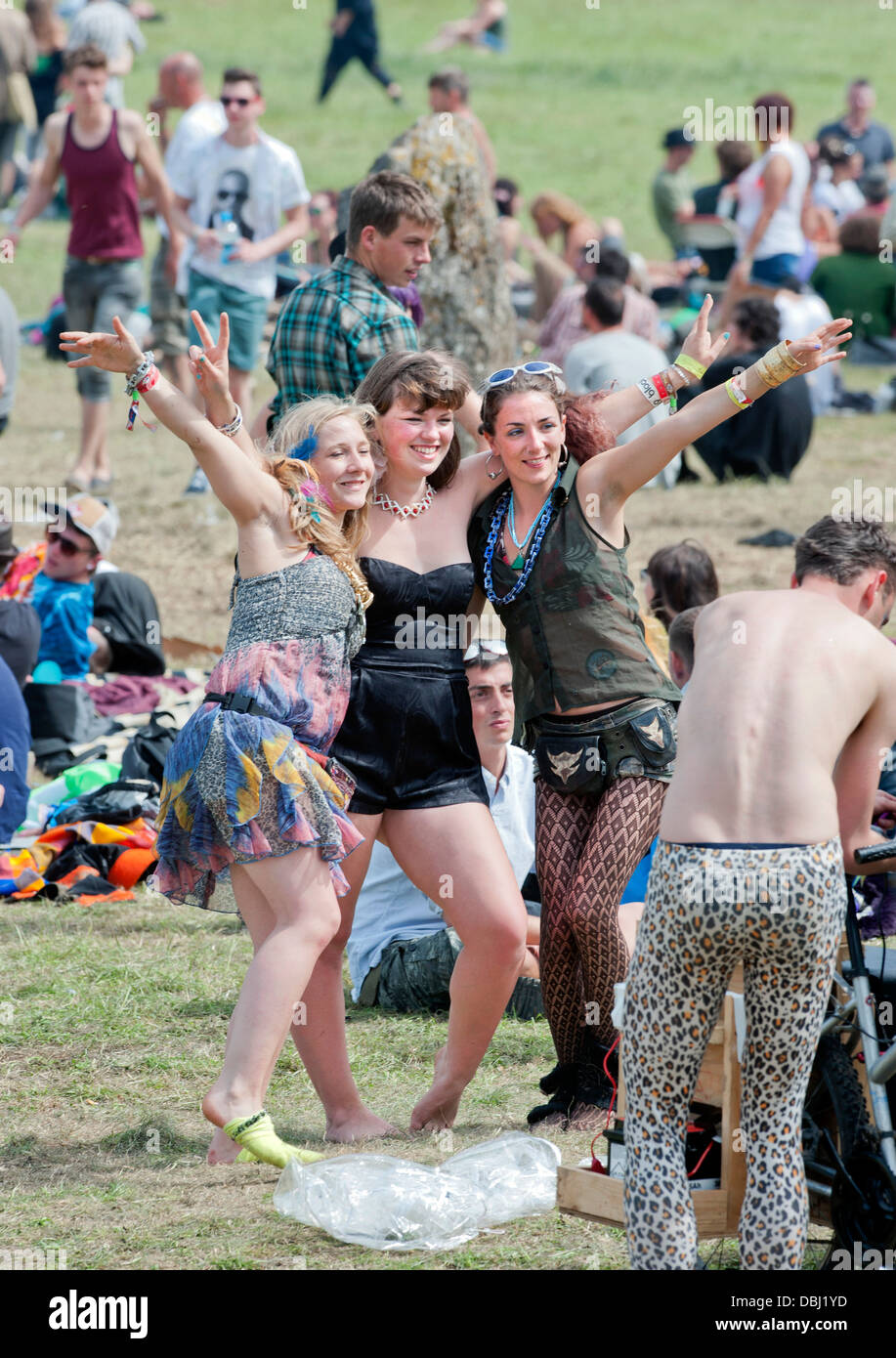 Glastonbury Festival 2013 UK - Three girls have their photograph taken near the stone circle. Stock Photo