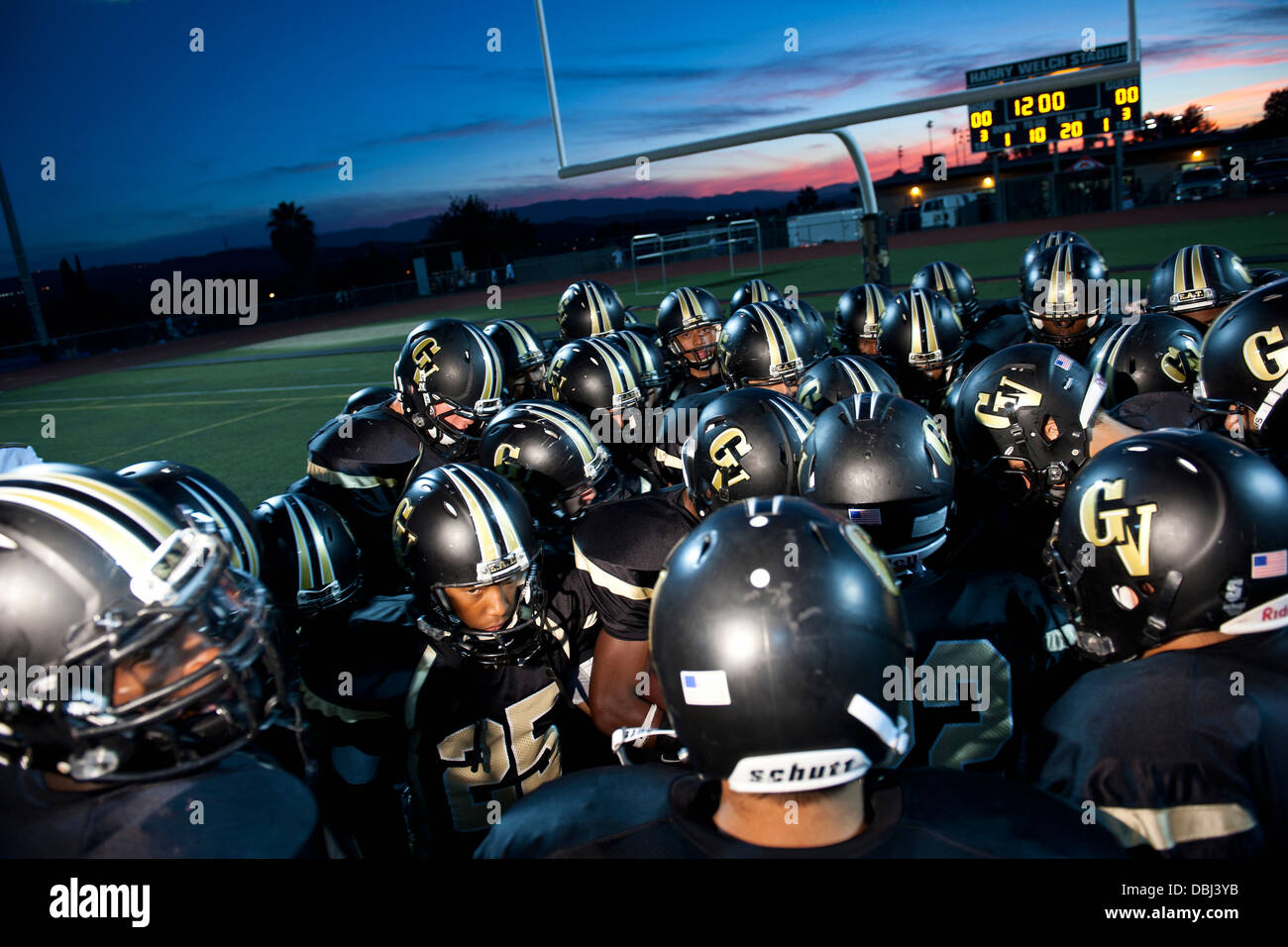 High school football players huddle before their game. Stock Photo