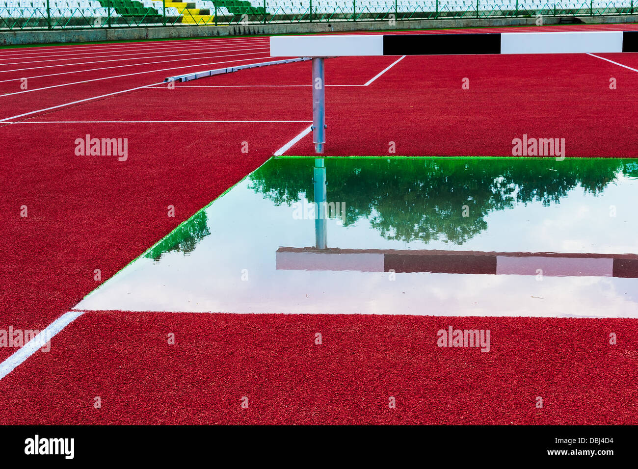 Athletic track with hurdle to jump over water Stock Photo