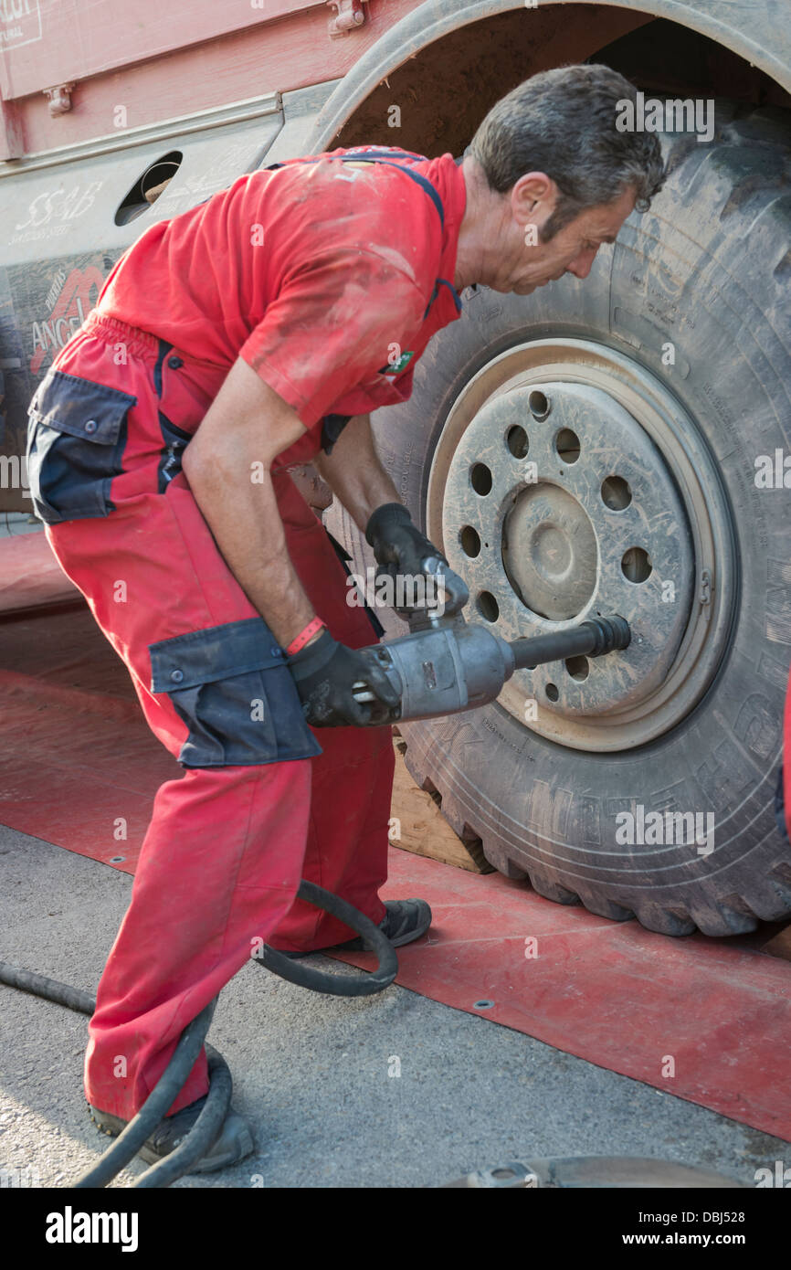 Mechanic working on a truck wheel during the 2013 Bajar Aragon Stock Photo