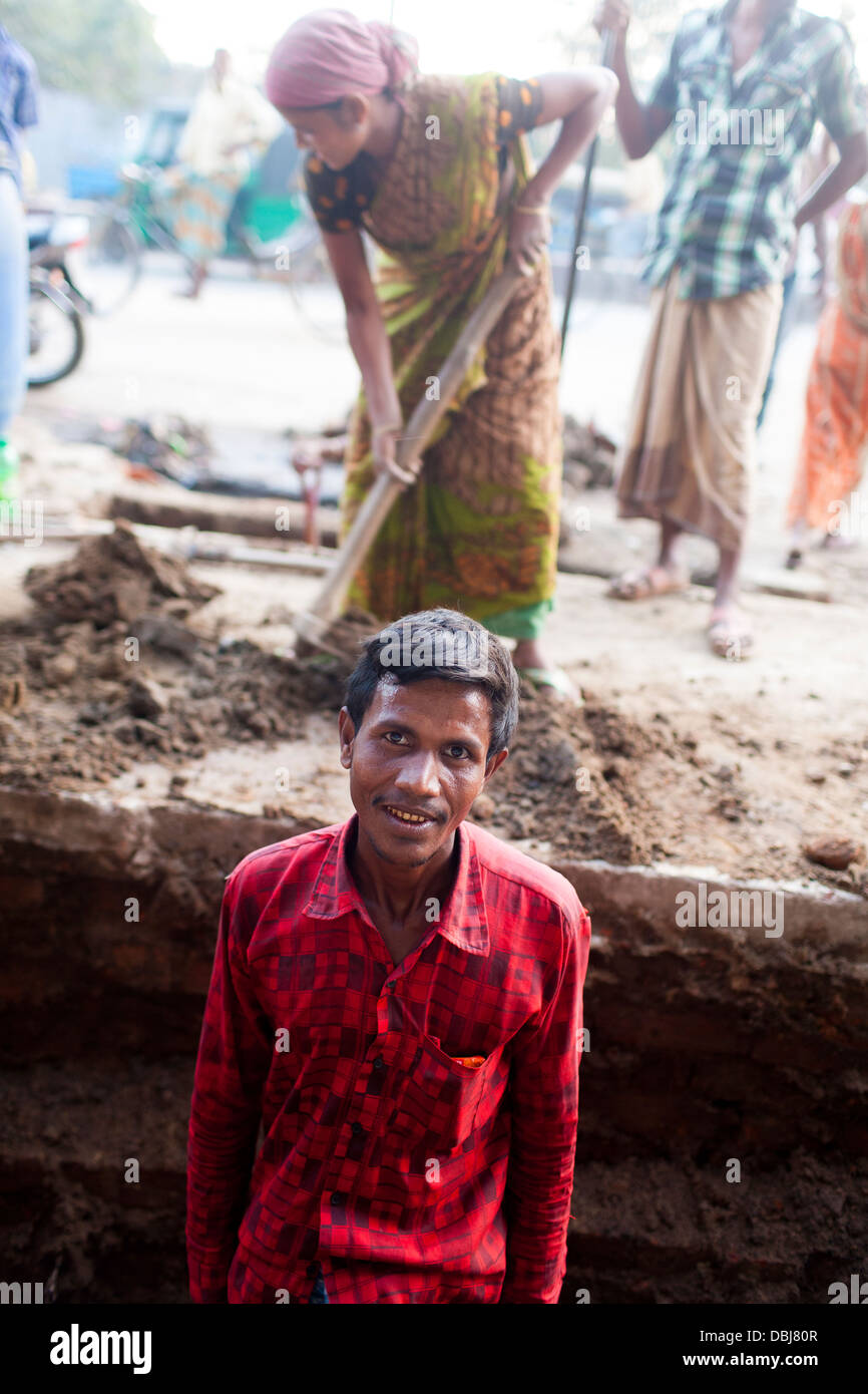 Rural Bangladeshi women perform manual labor carrying dirt for three dollars 3 a day on a road