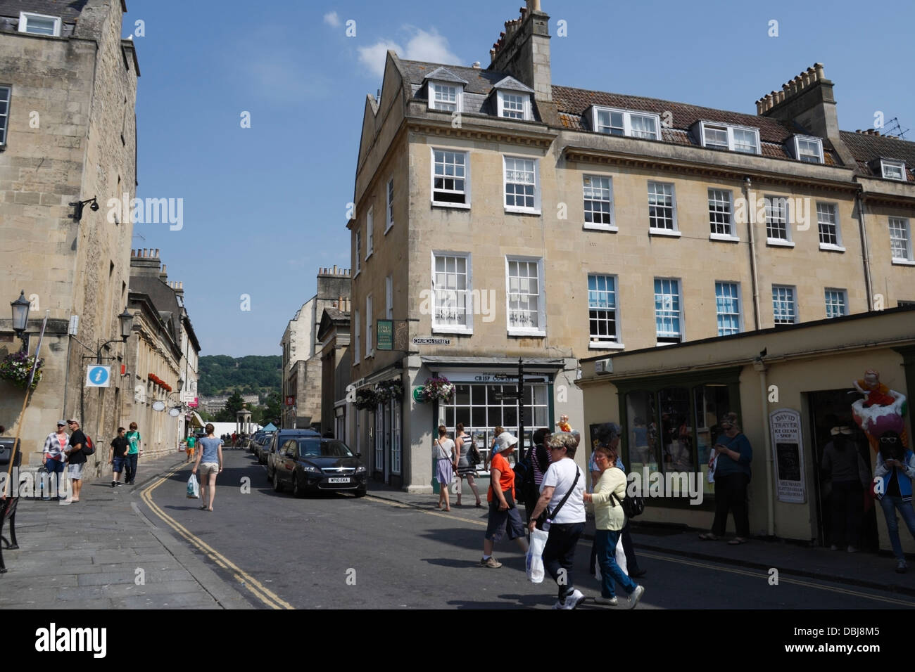 People walking across a street in Bath England UK Stock Photo