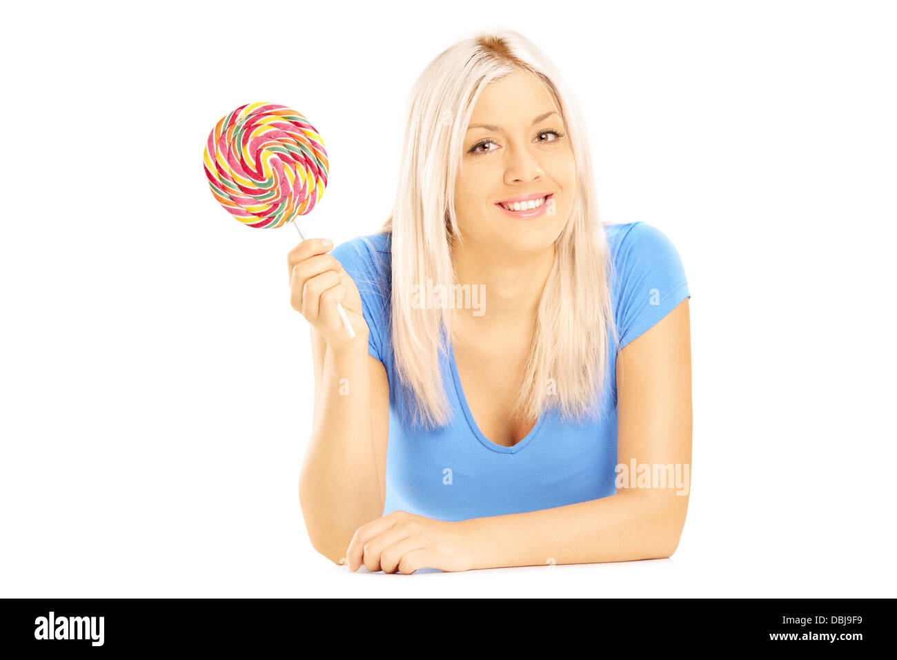 Blond female lying down with lollipop and looking at camera isolated on white background Stock Photo