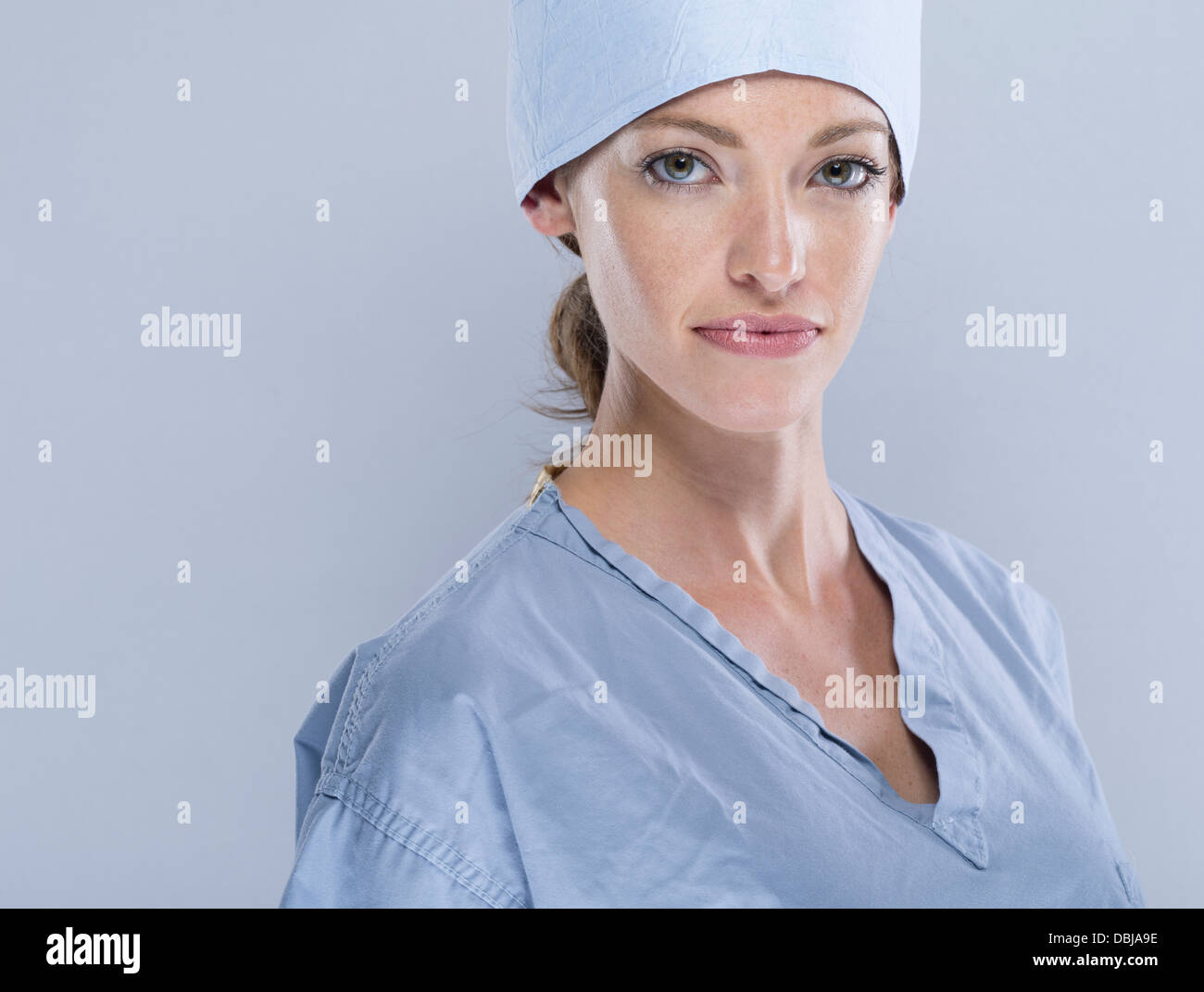 Female medic wearing surgical scrubs cap and mask Stock Photo Alamy