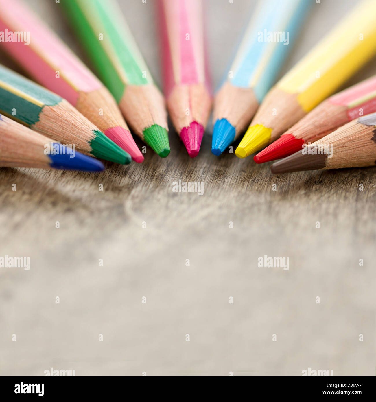 Macro closeup of colorful wooden color pencils on rustic background and selective focus and copy space - back to school concept Stock Photo