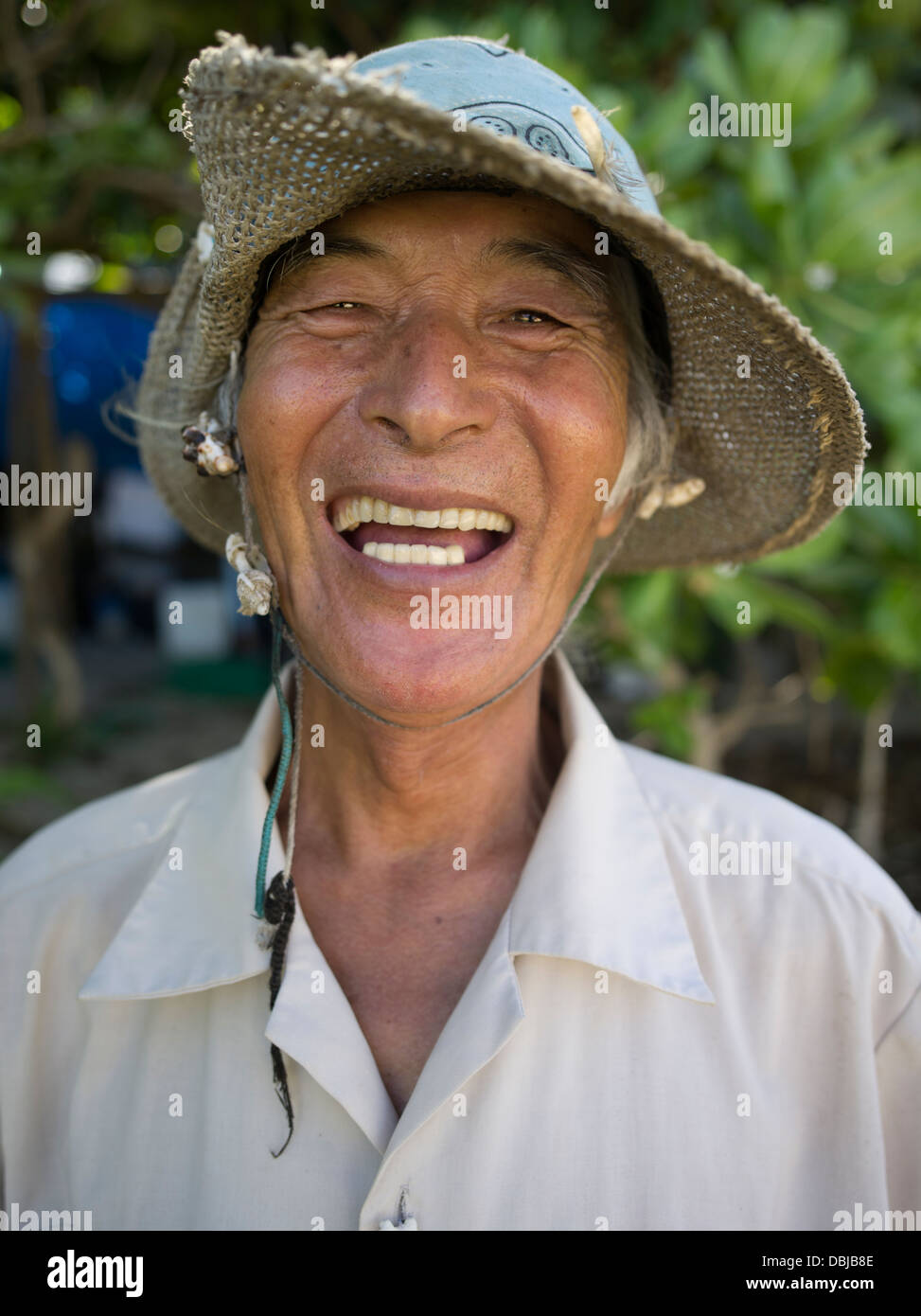 Okinawan man at Yoshino Beach - Miyako Island, Okinawa, Japan. Okinawan people have one of the longest life expectancies Stock Photo