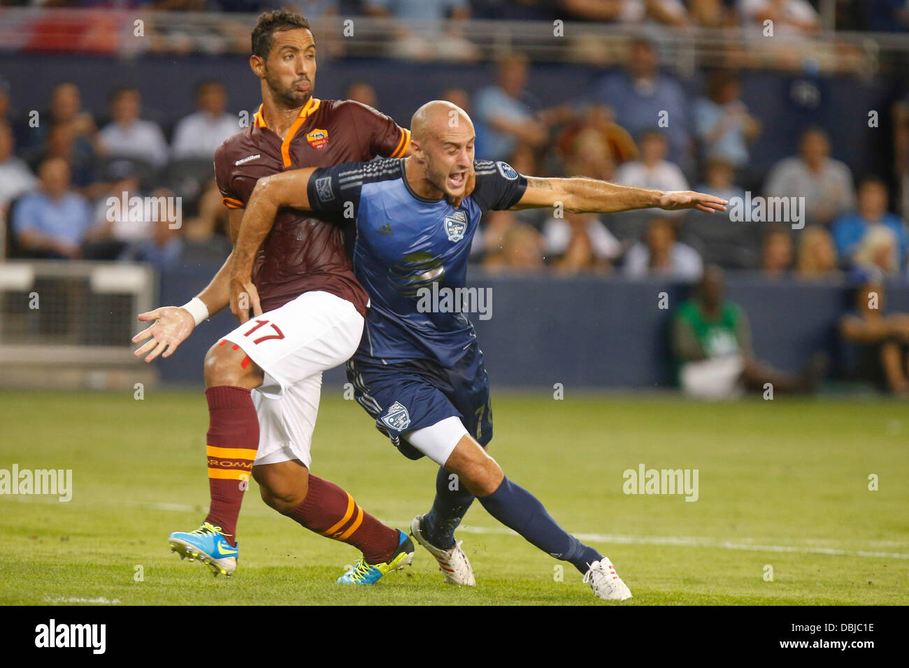 Kansas City, KS, USA. 31st July, 2013. July 31, 2013: Aurelien Collin #78 of the MLS All-Stars is taken down to the ground by Mehdi Benatia #17 of the AS Roma late in the first half during the MLS All-Star game between AS Roma and the MLS All-Stars at Livestrong Stadium in Kansas City KS Credit:  csm/Alamy Live News Stock Photo
