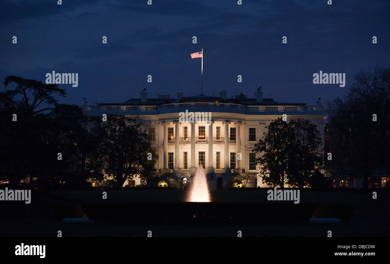 The White House, home of the President of the United States, seen from the South Lawn at dusk in Washington DC, USA. Stock Photo