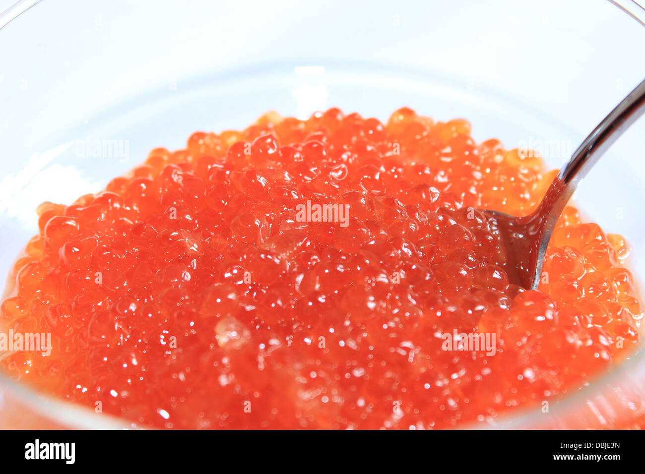 image of red caviar in a plate with the spoon Stock Photo