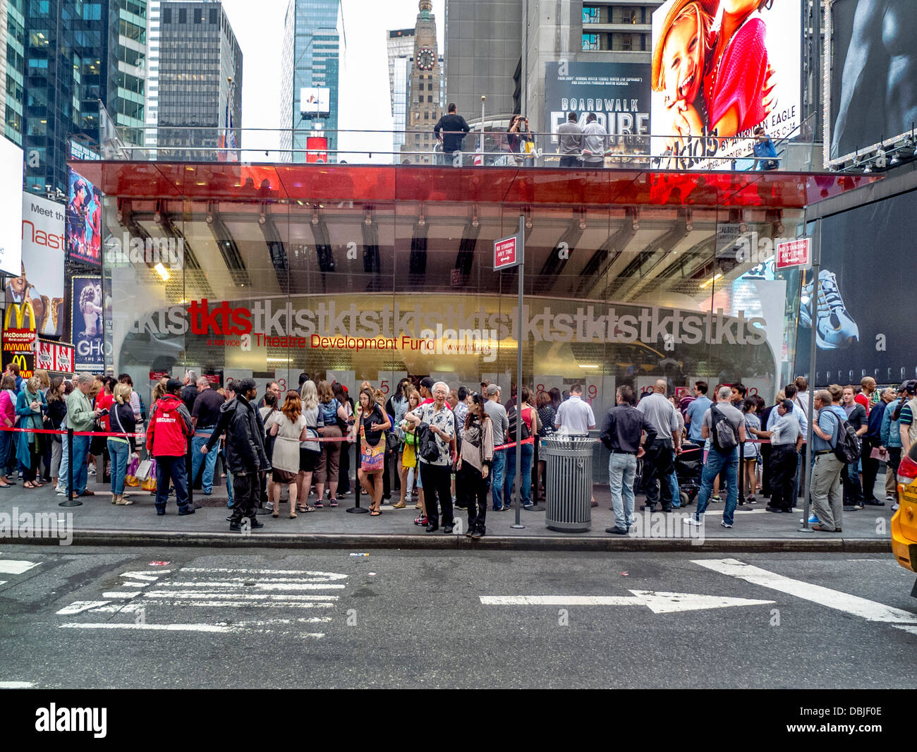 Customers line up to buy discount theater tickets at the famous TKTS sales facility in Duffy Square, New York City. Stock Photo