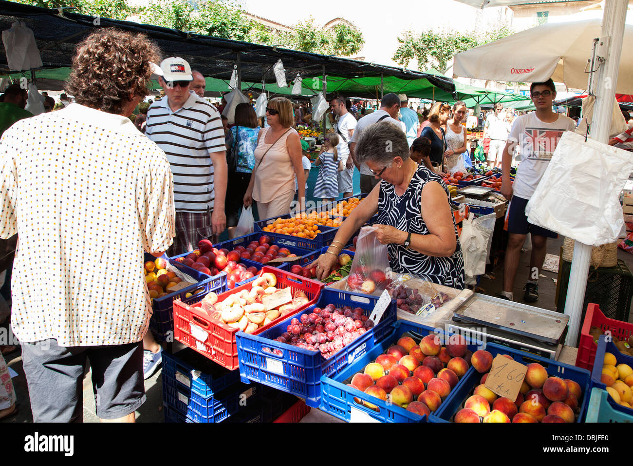 Fruit and vegetable stalls at the Pollensa old town Sunday market in the the main Plaza Mayor square Stock Photo