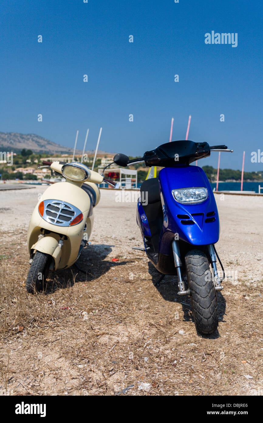 Two scooters on the beach at Avlaki Corfu Stock Photo