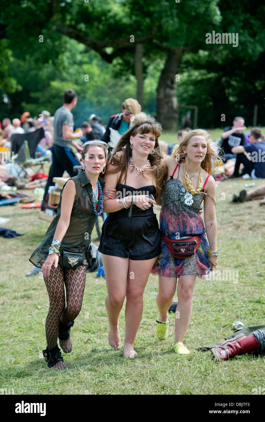 Glastonbury Festival 2013 UK Three girls support each other near the stone circle Stock Photo