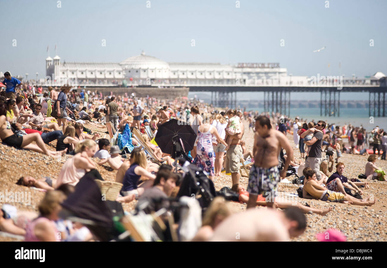 People enjoying the hot sunshine on Brighton Beach on 26th June. Today is set to be the hottest day of the year, with forecasters predicting temperatures will hit 30c (86F). Brighton, England - 26.06.11 Stock Photo