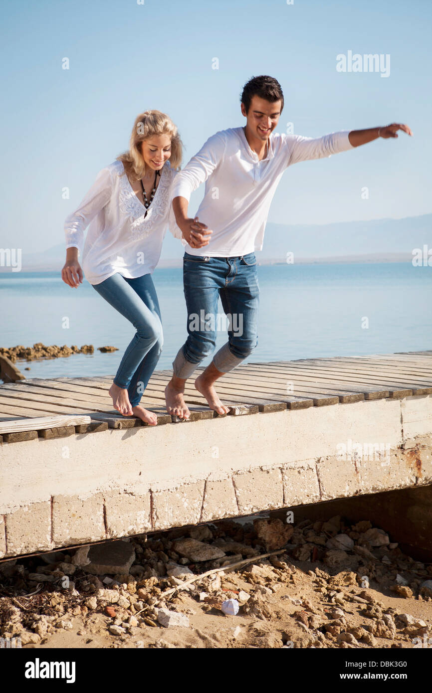 Croatia, Young couple jumping on beach Stock Photo
