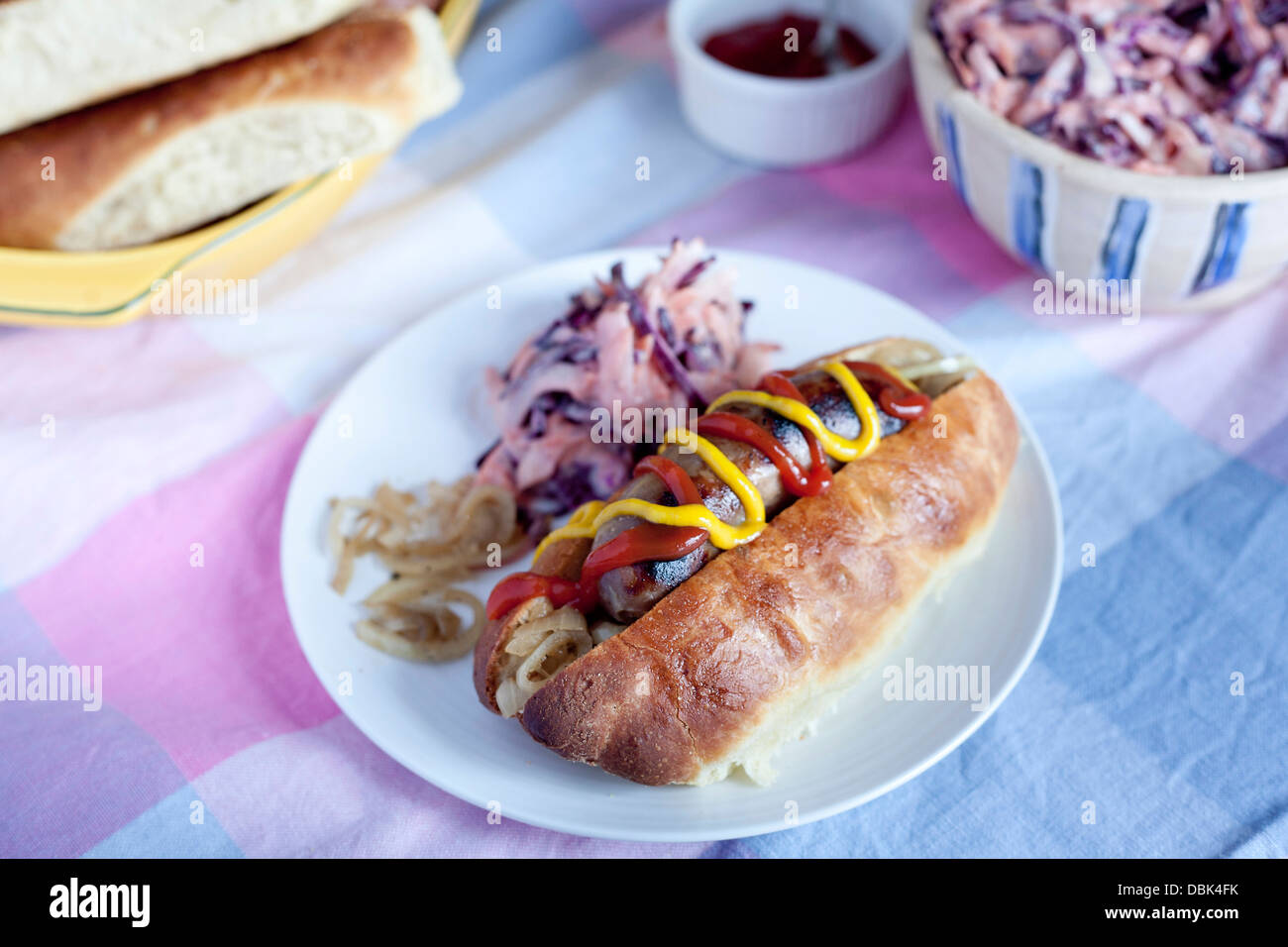 Organic hot dog, sausage and bun, with slaw, mustard and ketchup