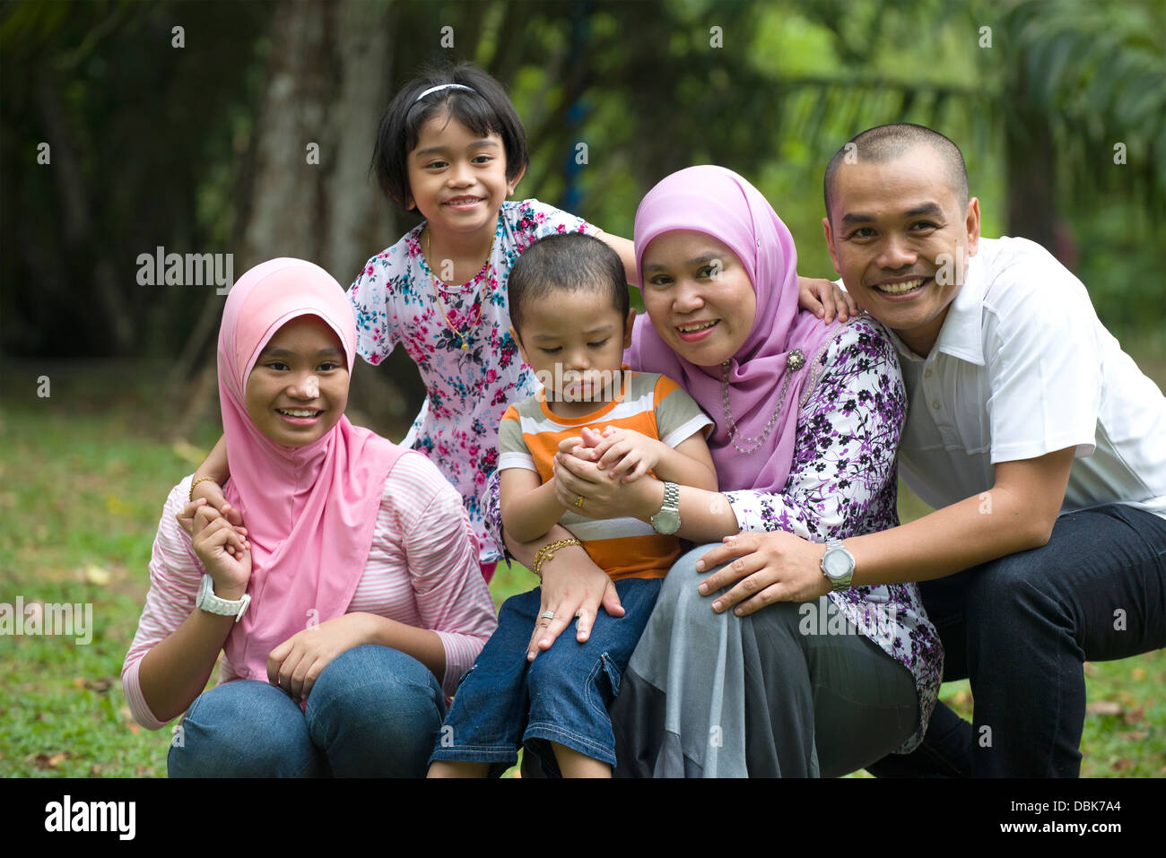 malay muslim family having fun in the park Stock Photo - Alamy