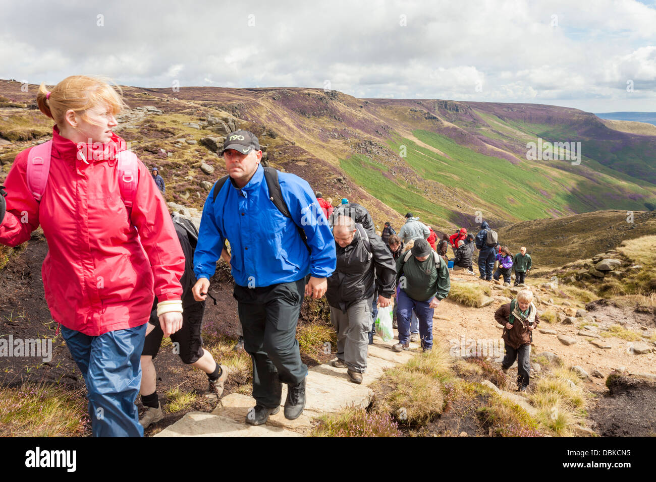 Large walking group. Hill walkers reaching the top of Kinder Scout, Derbyshire, Peak District, England, UK Stock Photo