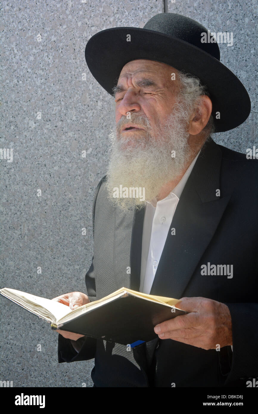 Religious Jewish man in fervent prayer at the Ohel, the resting place ...