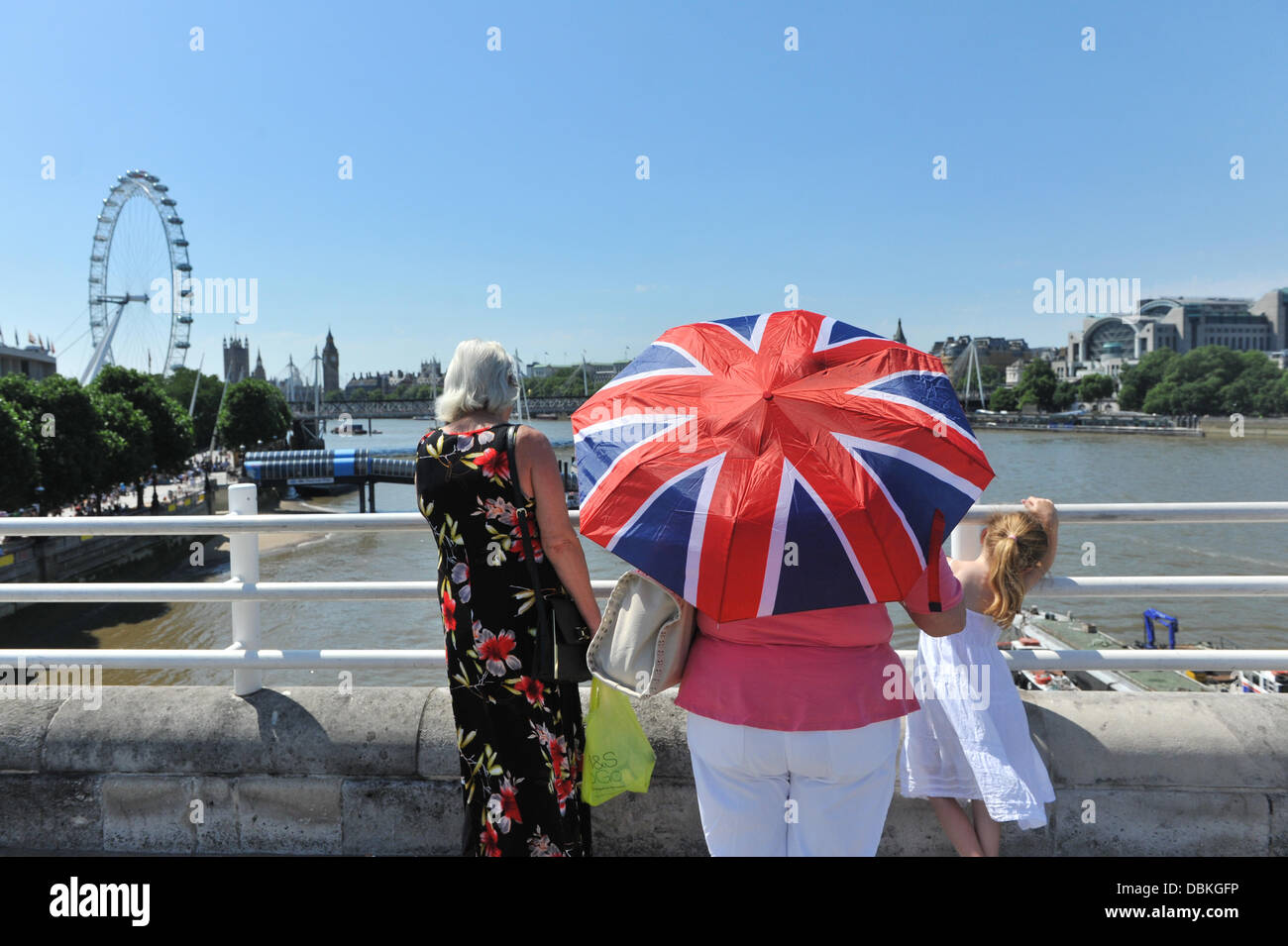 Waterloo Bridge, London, UK. 1st August 2013. A Union Jack umbrella acts as  a parasol for