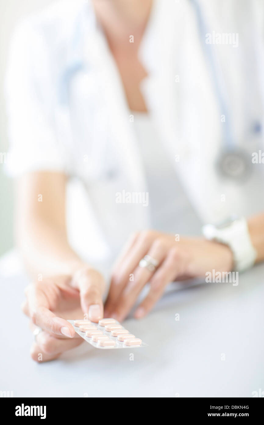 Gynecologist Holding Birth Control Pill in Hands Stock Photo