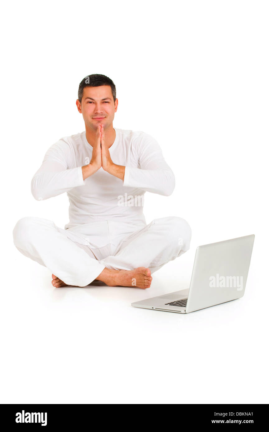 man dressed in white sitting on the floor practicing yoga with l Stock ...