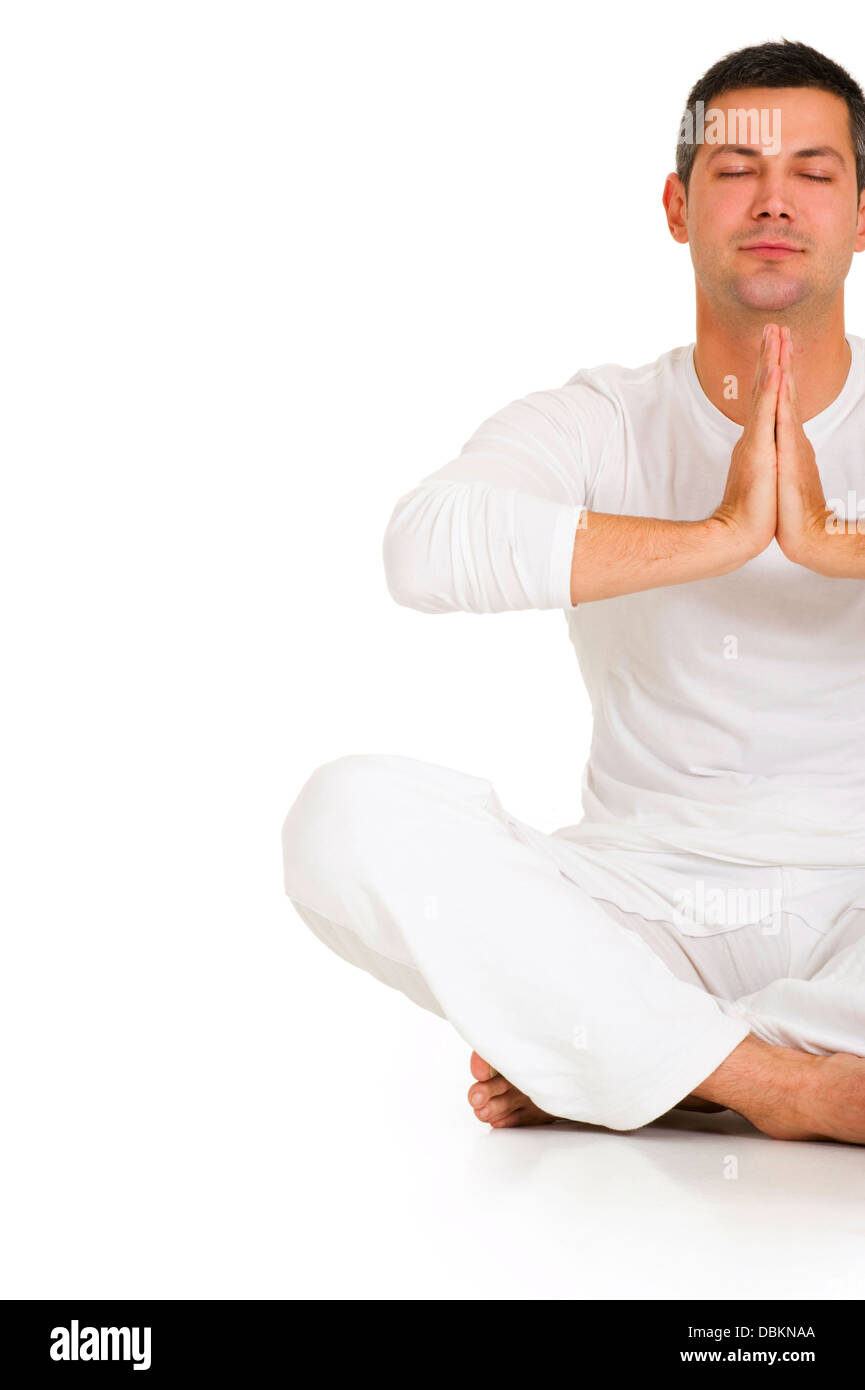 man dressed in white sitting on the floor practicing yoga Stock Photo ...